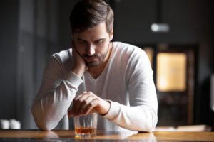 Man hunched over drink